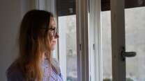 Nataliia, a Ukrainian woman in Trieste, looking out the window